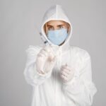 Healthcare professional in full protective gear preparing for Ebola outbreak response