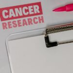 Personalized mRNA cancer vaccine research documents and pink ribbon