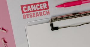 Personalized mRNA cancer vaccine research documents and pink ribbon