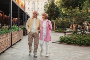 Active senior couple walking outdoors for brain health