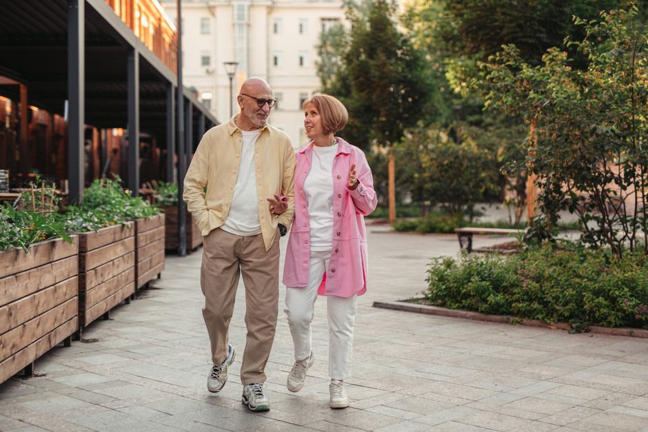 Active senior couple walking outdoors for brain health