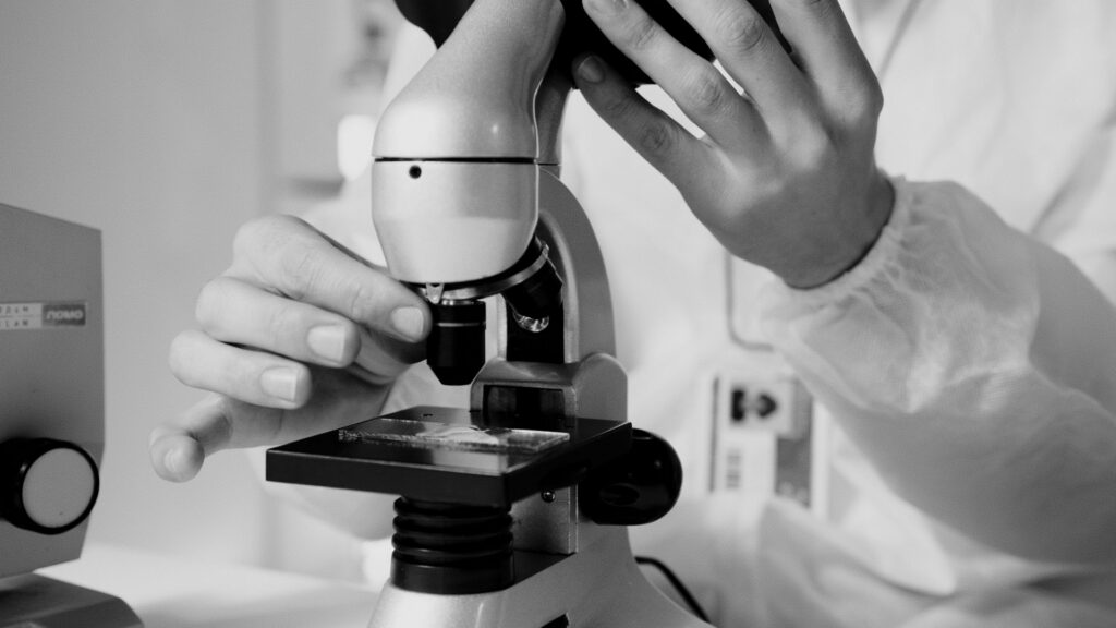 Scientist using a microscope in a laboratory during emerging infectious disease research