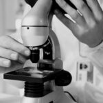 Scientist using a microscope in a laboratory during emerging infectious disease research