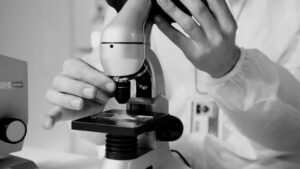 Scientist using a microscope in a laboratory during emerging infectious disease research