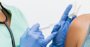 Nurse administering an mRNA flu vaccine