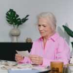 Elderly woman enjoying memories through old photographs