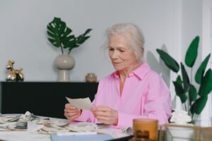 Elderly woman enjoying memories through old photographs