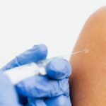 Healthcare professional administering the mRNA flu vaccine mFlusiva
