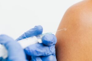 Healthcare professional administering the mRNA flu vaccine mFlusiva